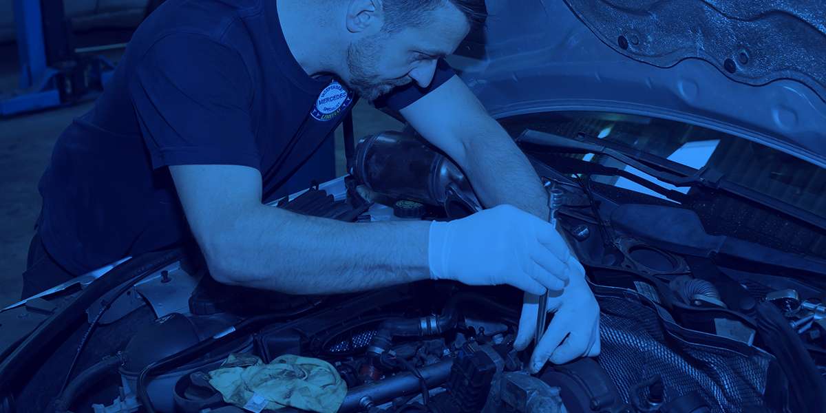 A technician servicing a Mercedes